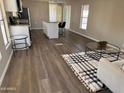 Bright open floorplan with updated kitchen, wood floors, and view to a modern living room at 205 S Higley Rd # 4, Mesa, AZ 85206