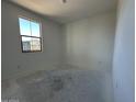 An empty bedroom with freshly painted walls and a single window for natural light at 22836 E Lords Way, Queen Creek, AZ 85142