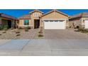 Tan house with white garage door and landscaped yard at 24862 N 172Nd Ave, Surprise, AZ 85387