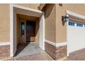 House entrance with brown door and brick walkway at 24862 N 172Nd Ave, Surprise, AZ 85387