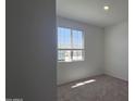 Bright bedroom features new carpet and a window with outside views at 2690 E Abe Truckle Ave, San Tan Valley, AZ 85140