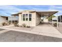 Mobile home exterior view with carport at 300 S Val Vista Dr # 152, Mesa, AZ 85204