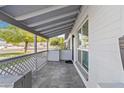 Covered front porch with tile flooring and wood accents at 3727 W Orangewood Ave, Phoenix, AZ 85051