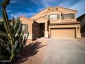 Two-story house with tan exterior and desert landscaping at 42796 W Oakland Dr, Maricopa, AZ 85138