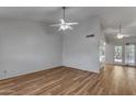 Bright living room with light wood floors and ceiling fan at 4556 N 88Th Ave, Phoenix, AZ 85037