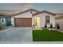 Charming home with a brown garage door and well-manicured lawn at 5658 N 206Th Ln, Buckeye, AZ 85396