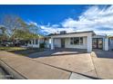 Updated mid-century modern home with carport and landscaped front yard at 8349 E Columbus Ave, Scottsdale, AZ 85251