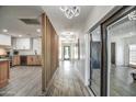 Bright hallway with wood-look floors, connecting kitchen to other rooms at 8349 E Columbus Ave, Scottsdale, AZ 85251