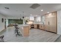 Modern kitchen with light wood cabinets, stainless steel appliances, and a large island at 8349 E Columbus Ave, Scottsdale, AZ 85251