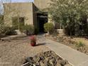 Inviting front entry with walkway and drought-tolerant landscaping at 11386 E Greythorn Dr, Scottsdale, AZ 85262