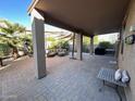 Covered patio with seating area, grill, and paver stones at 15936 W Canterbury Dr, Surprise, AZ 85379