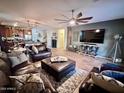 Spacious living room with leather furniture and a large TV at 15936 W Canterbury Dr, Surprise, AZ 85379