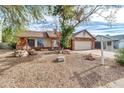 Landscaped yard with a brick ranch home and a two-car garage at 1715 N Silverado --, Mesa, AZ 85205