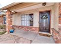 Inviting front door entrance with a brick facade and a porch at 1715 N Silverado --, Mesa, AZ 85205