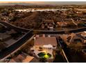 Stunning aerial view of a home with a pool and lake views at 17765 W Summit Dr, Goodyear, AZ 85338