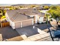 Aerial view of a single-story house with a three-car garage at 17765 W Summit Dr, Goodyear, AZ 85338