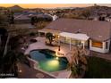 A backyard swimming pool, covered patio, desert landscaping at 17765 W Summit Dr, Goodyear, AZ 85338