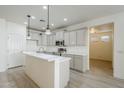 Open-concept kitchen featuring an island with a sink, stainless appliances, and gray shaker cabinets at 18526 E Swan Dr, Queen Creek, AZ 85142