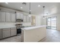 Spacious kitchen featuring stainless steel appliances, an island, and sleek countertops at 18526 E Swan Dr, Queen Creek, AZ 85142
