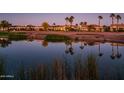 Luxury homes and lake with palm trees reflecting in the water at 23206 N Del Monte Dr, Sun City West, AZ 85375
