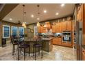 Spacious kitchen with an island, stainless steel appliances, and wood cabinets at 26398 W Cat Balue Dr, Buckeye, AZ 85396