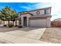Two-story house with a large tree and desert landscaping at 3109 E Denim Trl, San Tan Valley, AZ 85143