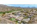 A beautiful aerial view of the home, with a manicured backyard and nice patio seating at 41512 N Tangle Ridge Ct, Anthem, AZ 85086