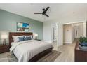Comfortable bedroom featuring a dark wood bed frame and views to the home's hallway at 41512 N Tangle Ridge Ct, Anthem, AZ 85086