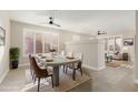 Bright dining area featuring a modern table and chairs, large windows, and a ceiling fan at 41512 N Tangle Ridge Ct, Anthem, AZ 85086