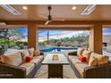 Relaxing patio with fire pit, comfortable seating, and a view of the pool and sunset at 41686 N 110Th Way, Scottsdale, AZ 85262