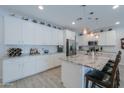 Modern kitchen featuring granite countertops and white cabinetry at 44049 W Palo Nuez St, Maricopa, AZ 85138