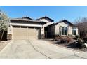Single-story home with a two-car garage and landscaped front yard at 5822 E Bramble Berry Ln, Cave Creek, AZ 85331