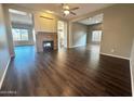 Open living room with hardwood floors and a fireplace at 5822 E Bramble Berry Ln, Cave Creek, AZ 85331