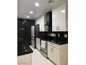 Modern kitchen with white cabinets, granite counters, and stainless steel appliances at 5954 W Townley Ave, Glendale, AZ 85302