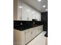 Modern kitchen with white cabinets and granite countertops at 5954 W Townley Ave, Glendale, AZ 85302