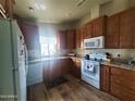 Galley kitchen with wood cabinets and modern appliances at 650 N Hawes Rd # 3702, Mesa, AZ 85207