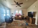 Living room with leather seating, wood floors, and large TV at 650 N Hawes Rd # 3702, Mesa, AZ 85207