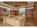 Spacious kitchen with large island and rich wood cabinets at 7150 N 64Th Pl, Paradise Valley, AZ 85253