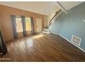 Living room with wood-look floors and stairs to upper level at 7324 N 44Th Dr, Glendale, AZ 85301