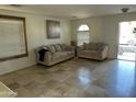 Living room with beige couches and tile flooring at 10617 W La Reata Ave, Avondale, AZ 85392