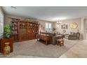Spacious living room featuring a large wooden cabinet and comfortable seating at 1113 W Fir Tree Rd, Queen Creek, AZ 85140