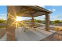 Relaxing gazebo with shaded picnic table for outdoor dining at 1167 W Chimes Tower Dr, Casa Grande, AZ 85122
