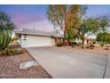 House exterior showcasing a driveway and desert landscaping at 13438 W Prospect Dr, Sun City West, AZ 85375