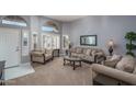 Cozy living room with ample natural light and comfortable seating at 14416 W Kiowa Trl, Surprise, AZ 85374