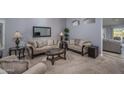 Elegant living room boasts plush sofas and a large mirror at 14416 W Kiowa Trl, Surprise, AZ 85374