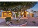 Landscaped front yard with mature tree and pathway to entry at 22728 N Arrellaga Dr, Sun City West, AZ 85375