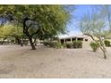 Landscaped backyard with gravel and mature trees at 24918 S Golfview Dr, Sun Lakes, AZ 85248