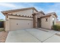 Light-colored stucco house with a two-car garage and stone accents at 29715 N 119Th Ln, Peoria, AZ 85383