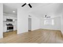 Bright living room with light wood flooring and ceiling fans at 3538 W Chambers St, Phoenix, AZ 85041