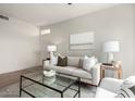 Living Room includes a sofa with bright lamps on side tables and modern art at 3830 E Lakewood E Pkwy # 2154, Phoenix, AZ 85048